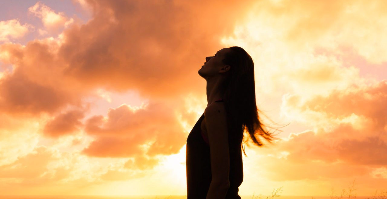 intuition from natural environment concept woman silhouette against orange sky