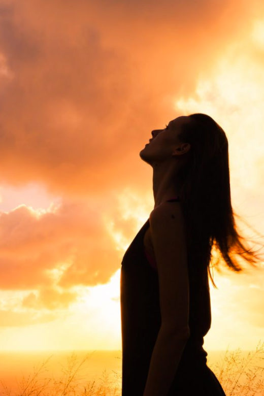 intuition from natural environment concept woman silhouette against orange sky