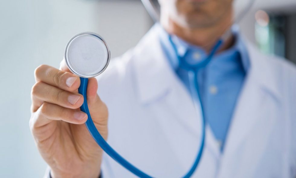 closeup doctor holding stethoscope